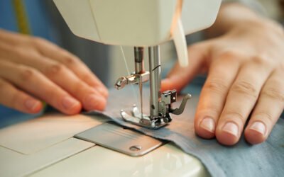 Tailoring processs Hands of female tailor using sewing machine at work
