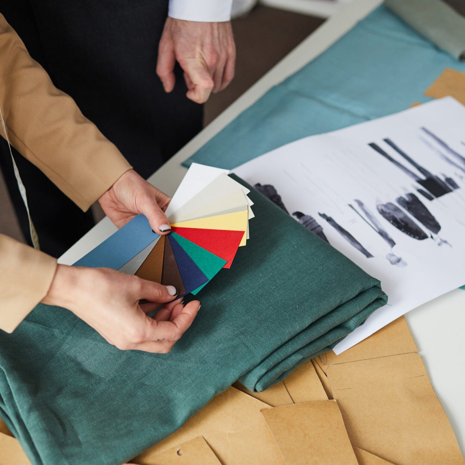 Close-up of designers choosing color of fabric for their future fashion collection of clothes
